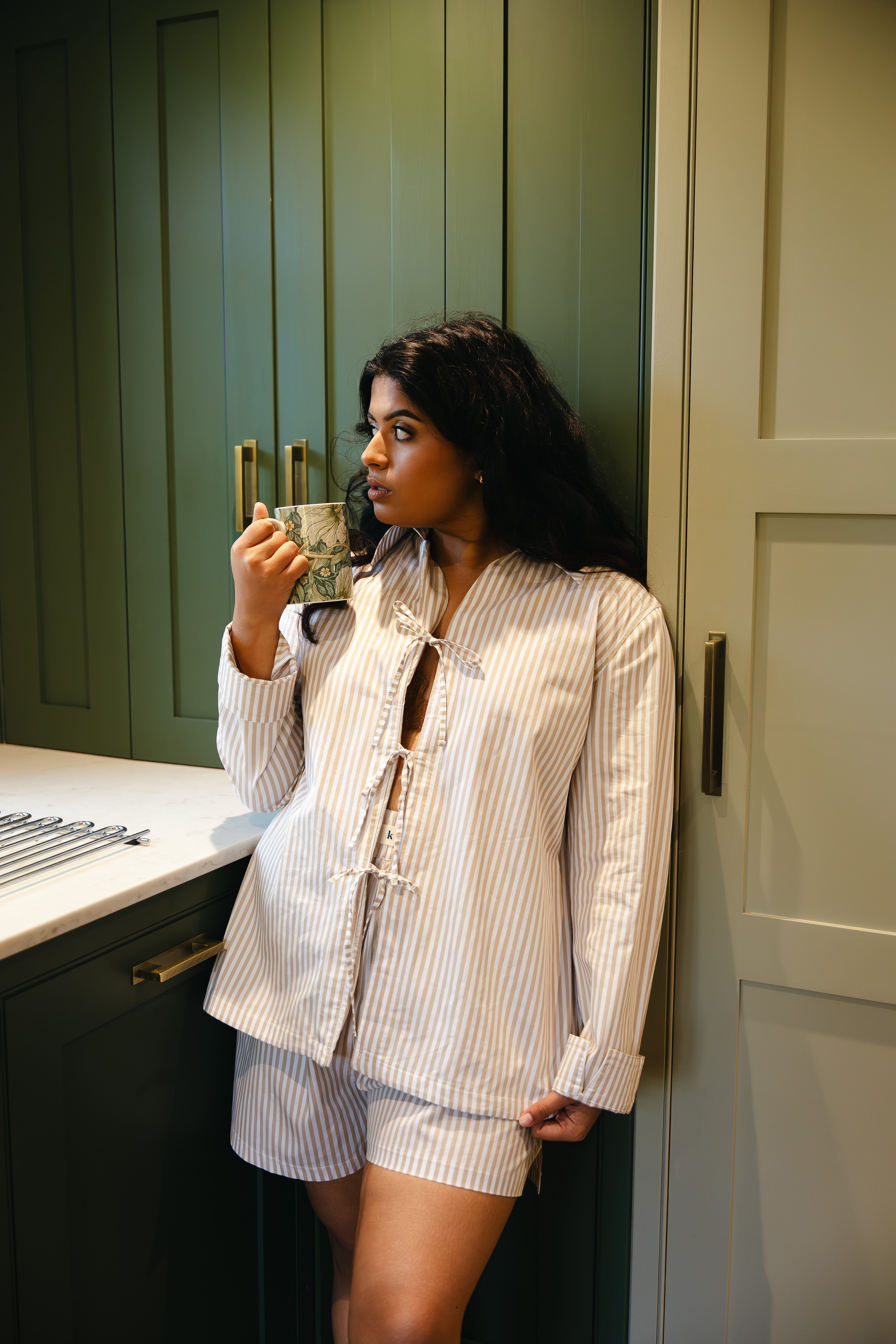 Model wearing pyjama neutral stripe long sleeve tie top and foldover waistband boxer shorts