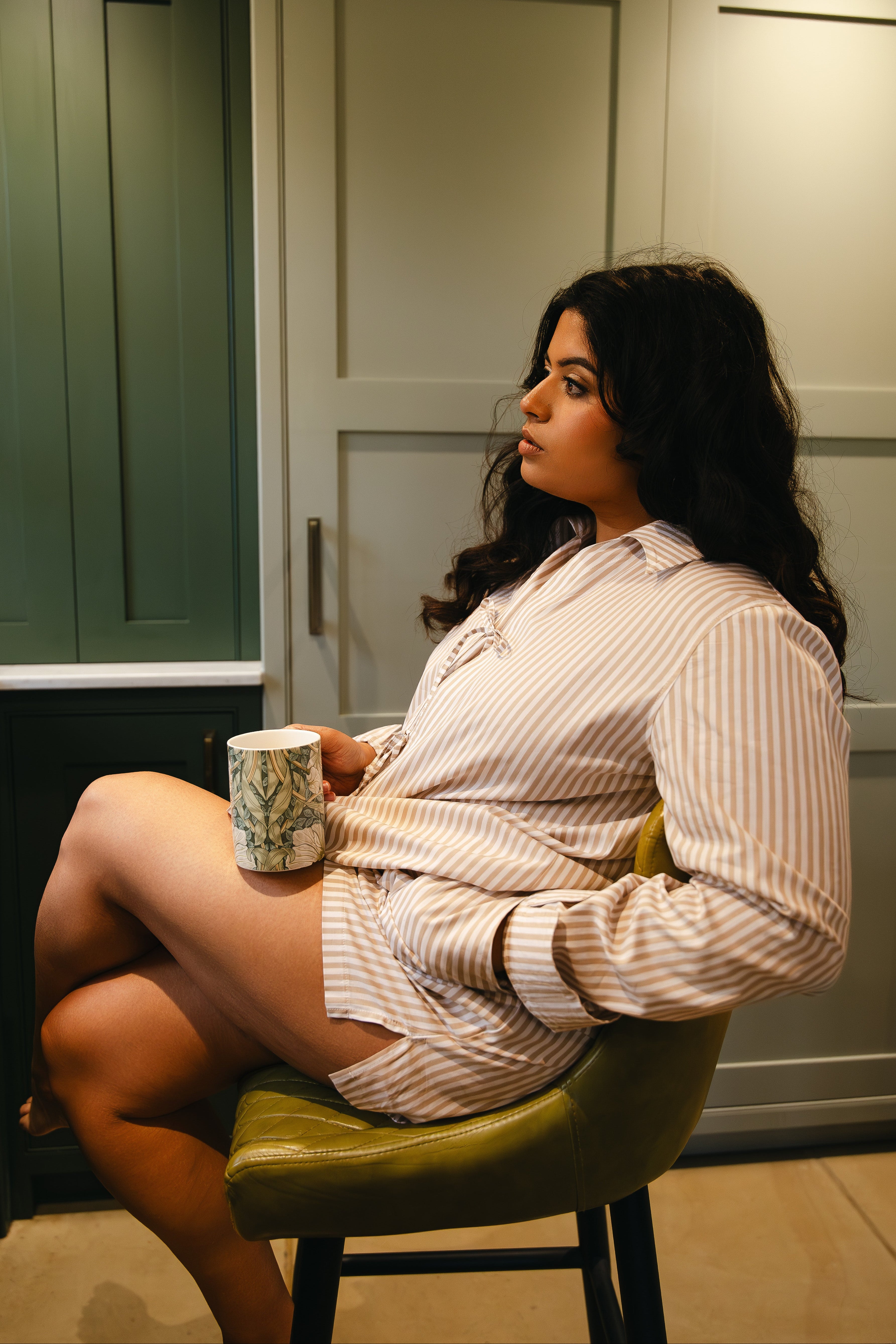 Model wearing neutral stripe pyjama long sleeve tie top and foldover waistband boxer shorts