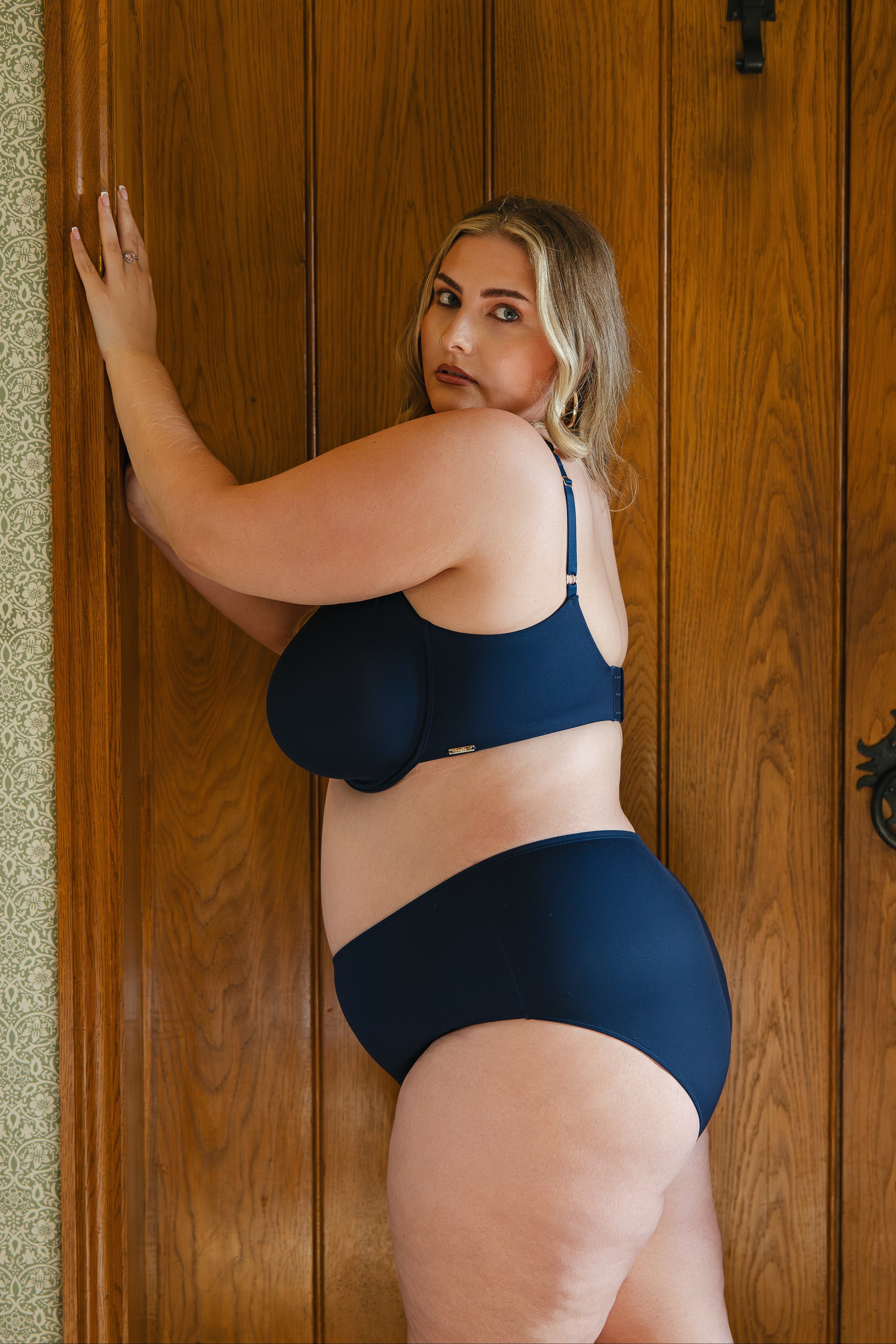 Model wearing midnight blue modal underwired bra and modal boyshort lingerie set